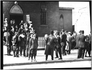 39.25 Jewish men and boys in synagogue doorway and on sidewalk